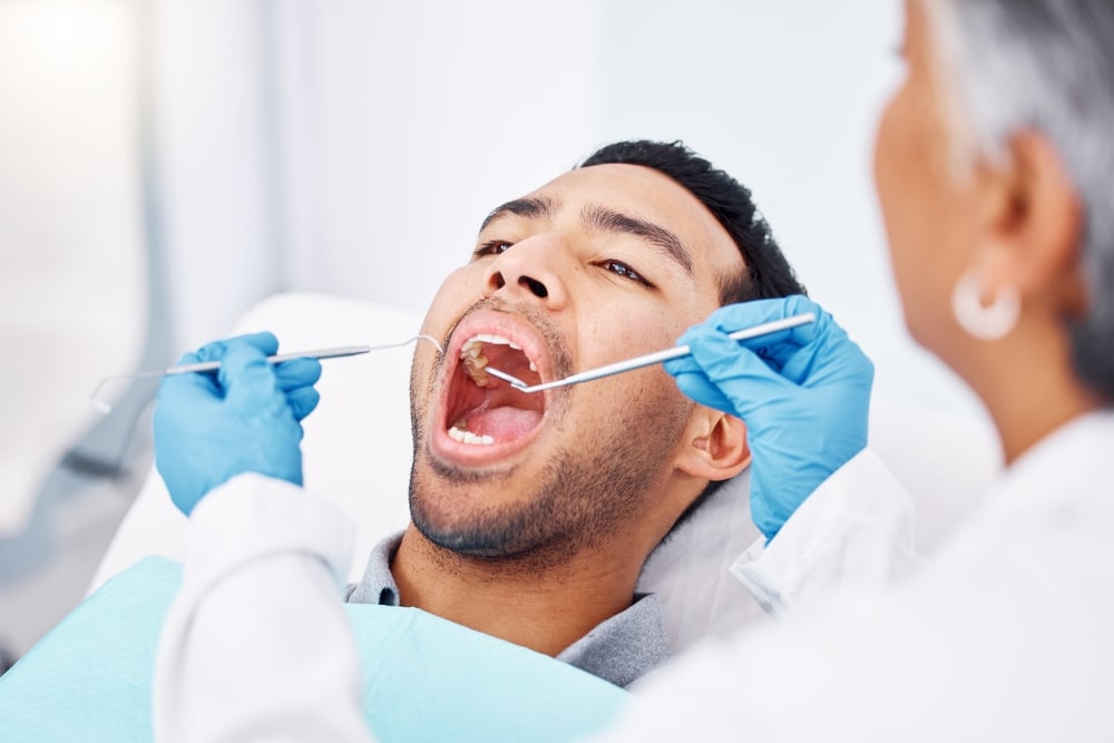 Patient receiving a dental examination and root canal treatment consultation