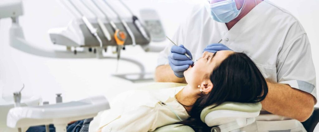 Dentist,With,Patient,In,Dental,Chair,Providing,Manipulations,In,Oral